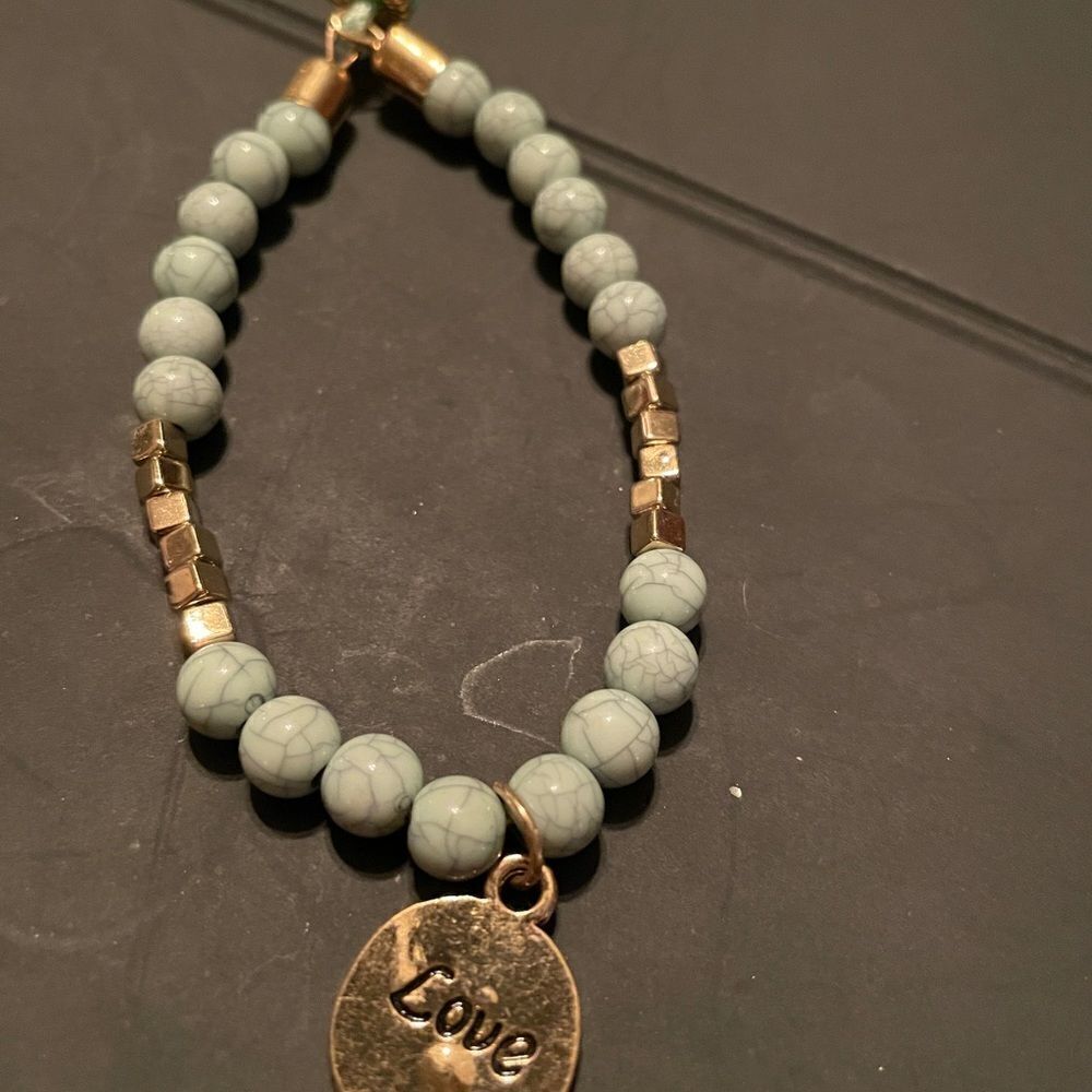 Gold tone Charm Bracelet with LOVE charm.